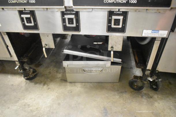 Henny Penny OFG-323 stainless steel gas fryer with dual bays on casters, 255,000 BTU, visible controls and filter pump.
