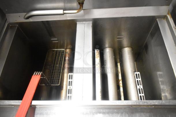 Henny Penny OFG-323 gas fryer, stainless steel, 2 bay, 255,000 BTU, on casters. Seen with baskets and heating elements.