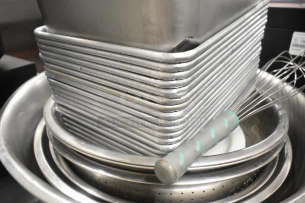 Lot of metal baking pans, stainless steel drop-in bins, and metal bowls, in good condition, for auction.
