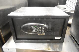 Amsec black single compartment safe with digital keypad, visible wear, no combination included.
