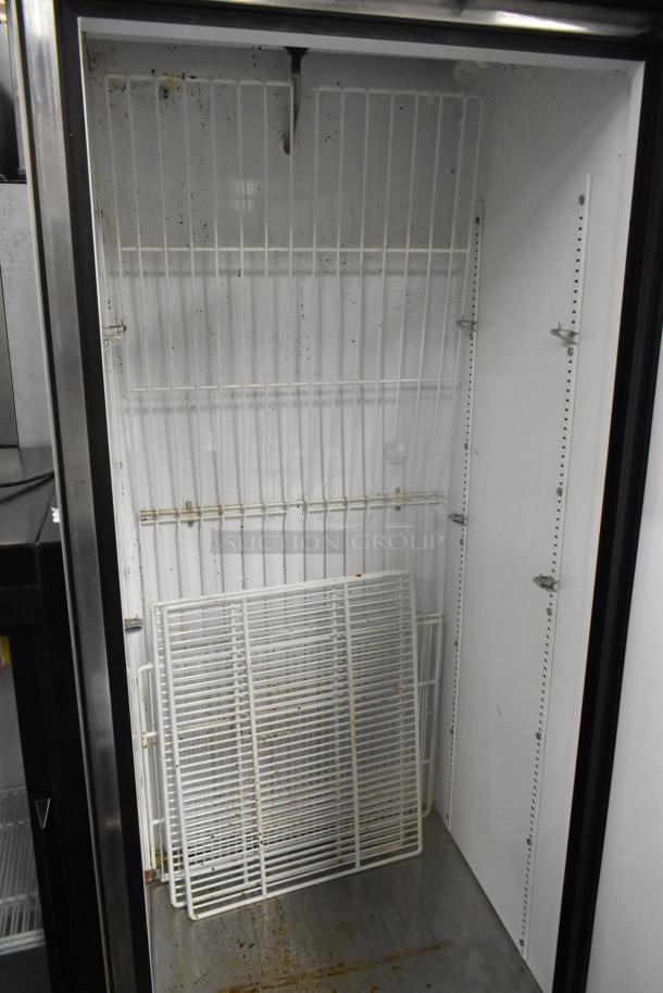 True T-19F stainless steel commercial freezer, single door, with poly coated racks, 115 volts, on casters, interior view.