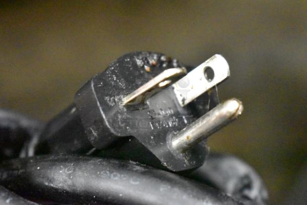 Close-up of a power plug for the Mayfair PA10301A electric griddle, showing details of prongs and slight wear.