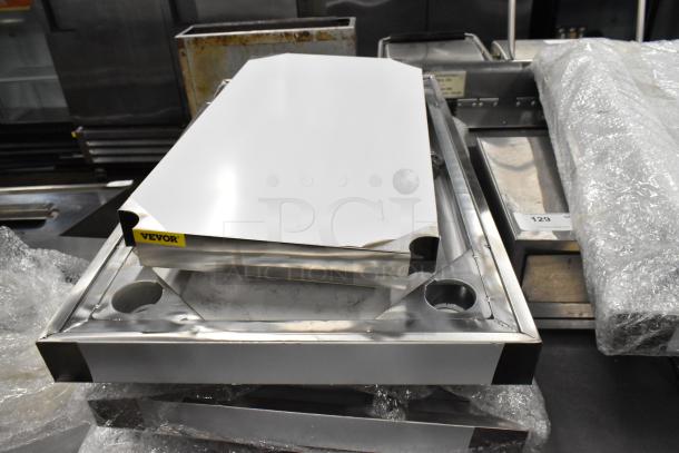 BRAND NEW SCRATCH AND DENT! Stainless Steel Tabletop w/ Under Shelf, Metal Legs and Commercial Casters. - Image 1 of 7