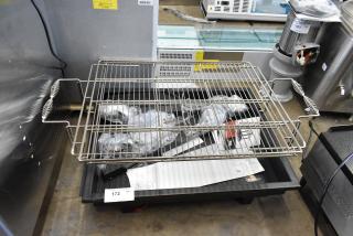 Brand new Backyard Pro Metal Charcoal Grill, scratch and dent condition, includes accessories and grill grate. Lot tag 172 visible.