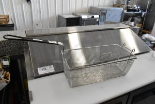 Avantco 184THD27208 new fryer basket, 17"x8.25"x6", front hook, stainless steel, with barcode sticker, on stainless surface.