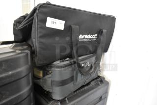 Two bags: a black Westcott duffel with logo and a wheeled grey luggage bag. Both in good condition, stacked together.