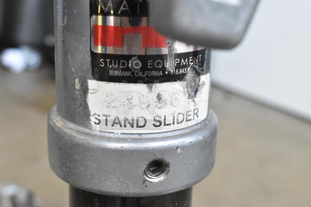 Matthew B339761 Tripod with visible "Stand Slider" label, showing wear. Made in Burbank, California.