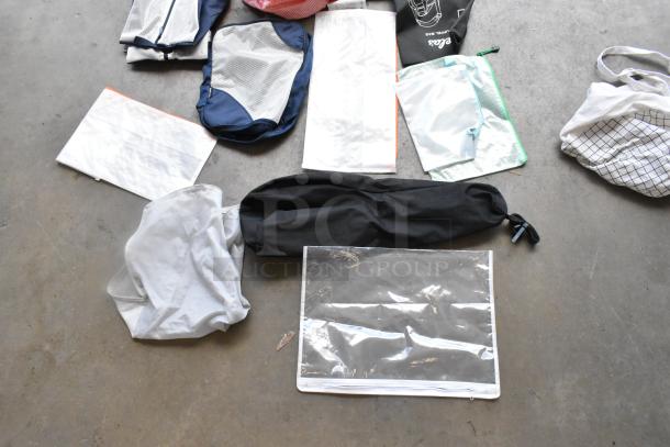 Lot of various bags, including mesh and fabric types, in mixed colors. Some have zippers and drawstrings. Used condition.
