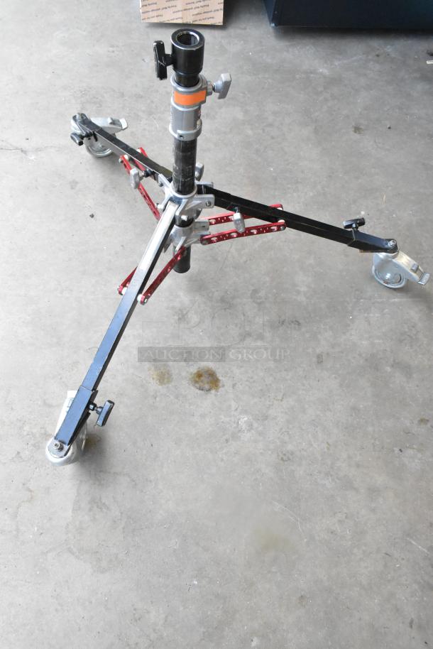 Matthew 249561 Stand Slider Tripod on casters, featuring adjustable arms, sturdy construction, visible wear on floor surface.