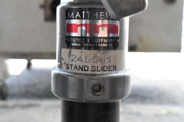 Matthew 249561 Stand Slider Tripod, labeled "Stand Slider," black metal, with visible Matthew Studio Equipment branding.