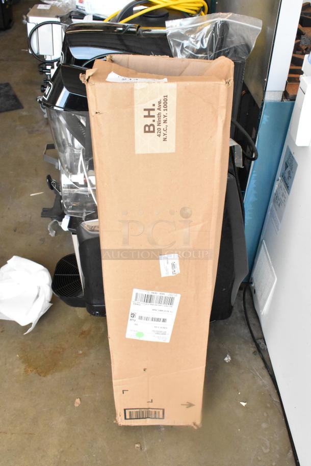Cardboard box containing Matthew 249561 Stand Slider Tripod on Casters; box shows some wear and shipping labels.