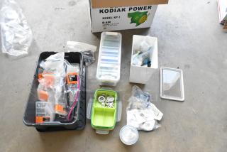Lot of miscellaneous items including washer kits, lock nuts, and assorted hardware, in various containers. Kodiak Power box visible.
