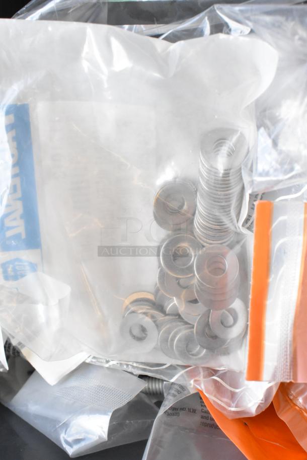 Lot of various items including metal washers, lock nuts in plastic bags. Condition appears new, suitable for hardware use.