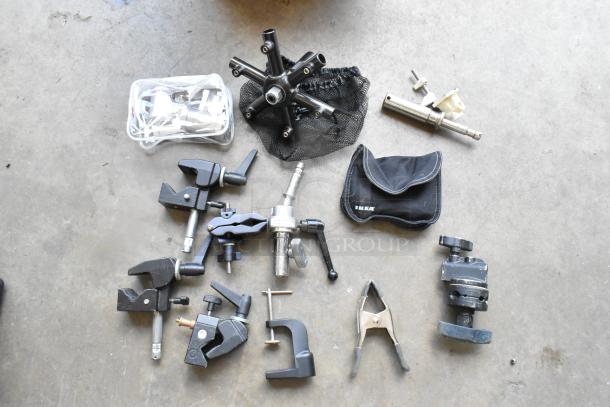Lot of various clamps in a hard bin, includes metal and plastic clamps, in good condition, some in Ikea pouch.