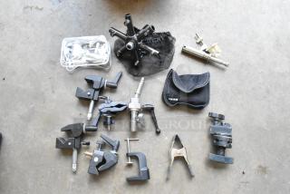 Lot of various clamps in a hard bin, includes metal and plastic clamps, in good condition, some in Ikea pouch.