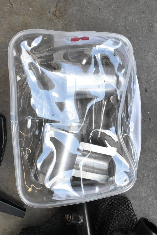 Lot of metal clamps in a clear hard bin, showing shiny silver finish. Clamps appear in good condition, suitable for various uses.