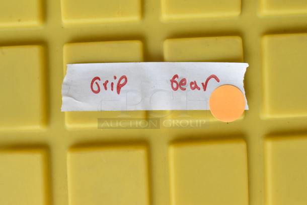 Yellow hard bin labeled "Grip Gear" with a round orange sticker.