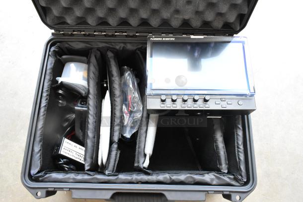 Flanders Scientific Zunzheng BM090 Broadcast Monitor with wires, housed in a durable hard case.
