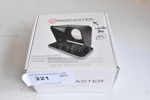 Padcaster Parrot Teleprompter in box, includes remote, 13 mounting rings, and cleaning kit, item 221 for auction.