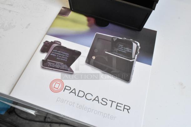 Padcaster Parrot Teleprompter in packaging. Features smartphone and camera compatibility. Brand logo and product images visible.