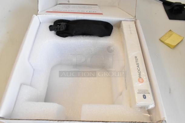 Padcaster Parrot Teleprompter in original packaging, includes a manual and accessories. New condition, ideal for filming setups.