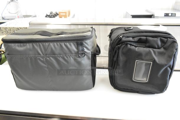 Two soft bags; gray and black. The gray bag has a top handle, and the black bag features a front ID slot. Both in good condition.