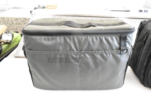 Two sturdy soft bags with zippers, black with gray accents. Features include handles and exterior pouches. Excellent condition.
