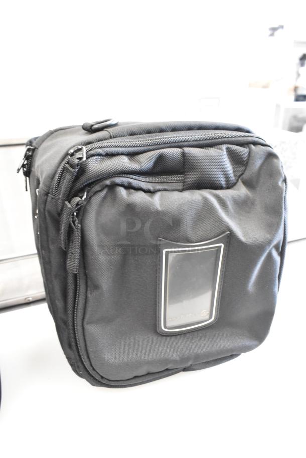 Black soft bag with multiple zippers and a transparent front pocket, ideal for travel or storage.