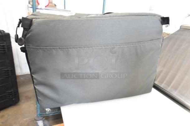 Gray soft bag with adjustable straps in good condition, featuring a front pocket. Includes auction deal: 2 bags for the price of 1.