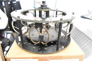 Vibration isolator with steel spring coils, circular metal frame, and mounting hardware, in good condition.