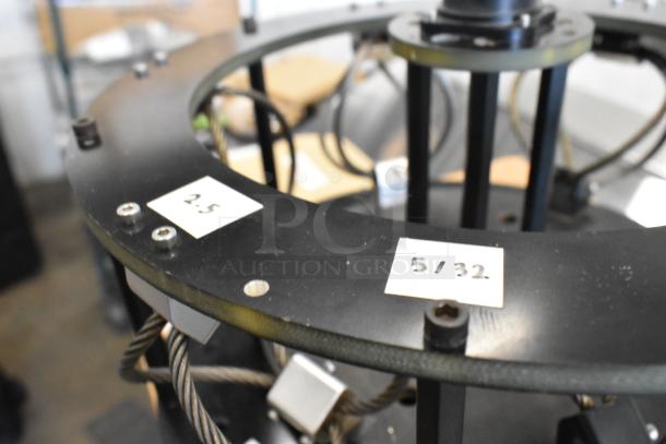 Vibration isolator with black metal frame, visible wire components, and labels marked "2.5" and "5/32."
