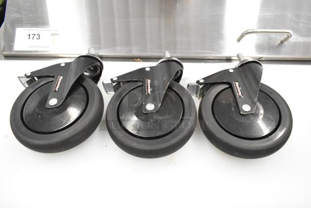 Box of 3 black commercial casters with swivel mount. Durable rubber wheels, visible brand marking "Katalina." Excellent condition.