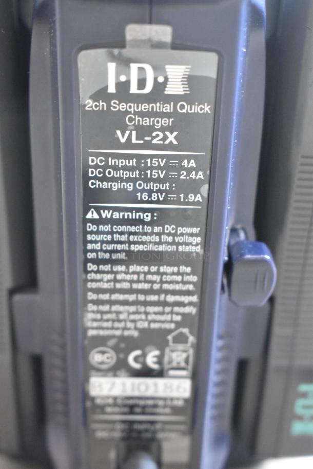 IDX VL-2X 2ch Sequential Quick Charger with rechargeable battery. Features visible specifications and warning label.