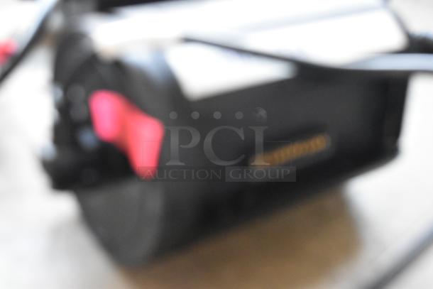 IDX VL-2X 2-channel sequential quick charger with rechargeable battery in a protective case, in used condition.