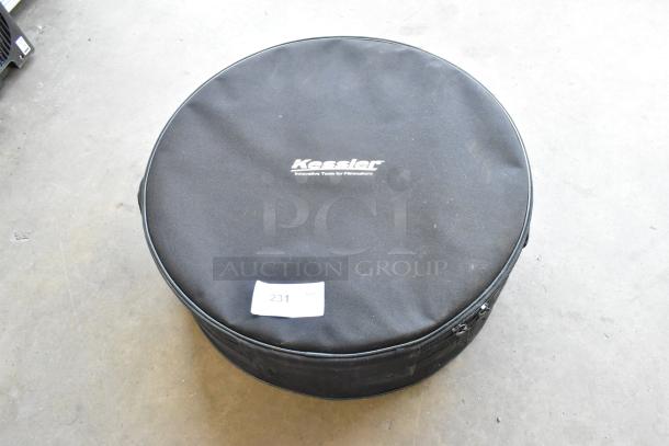 Kessler soft case with contents, black, round shape, logo visible, minor wear, zipper closure, marked with "231 QTY".