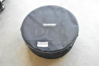 Kessler soft case with contents, black, round shape, logo visible, minor wear, zipper closure, marked with "231 QTY".