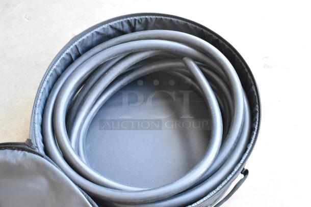 Kessler soft case with coiled hoses inside. Black zippered exterior, likely used for storage or transport.