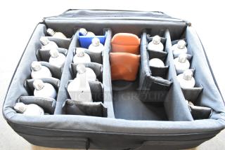 Case of lightbulbs with multiple compartments, holding various bulb types. Secure storage in padded, portable case.