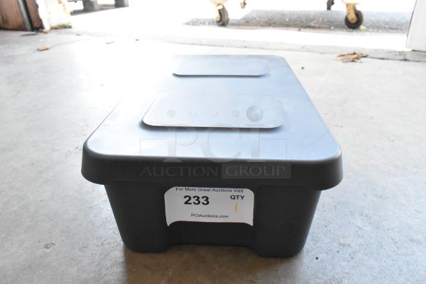 Black plastic storage bin with auction label. Contains Seagate FreeAgent Theater Roku Digital Video Player. Condition unknown.