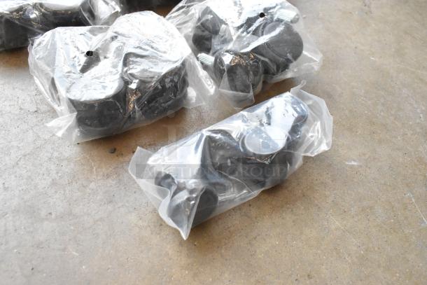 Lot of clips and casters in poly bin, sealed in clear bags, new condition; various sizes for diverse applications.