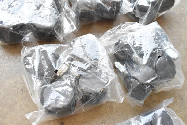 Lot of clips and casters in poly bin, sealed in clear plastic bags, new condition.