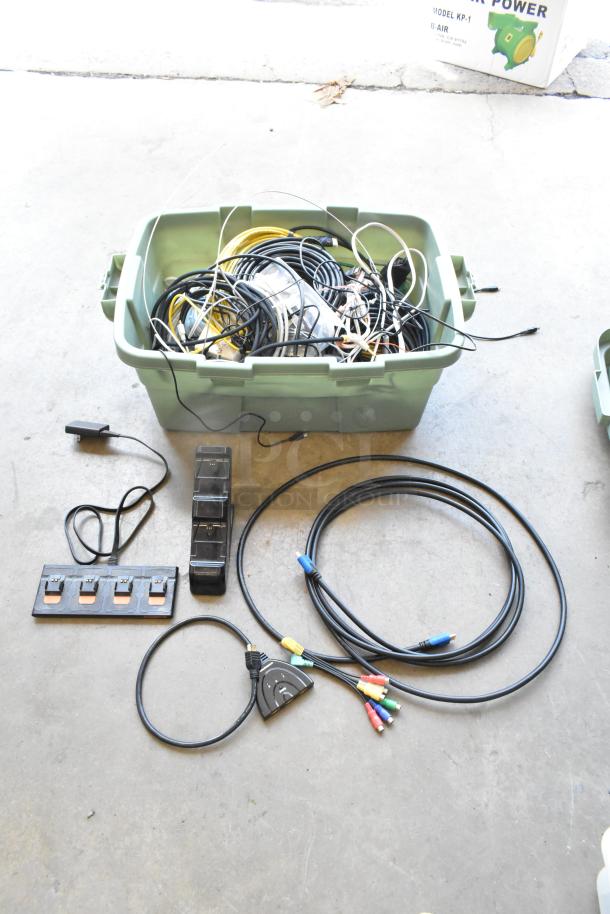 Lot of Anki unit and wiring in a green poly bin, includes cables and connectors, used condition, mixed colors.
