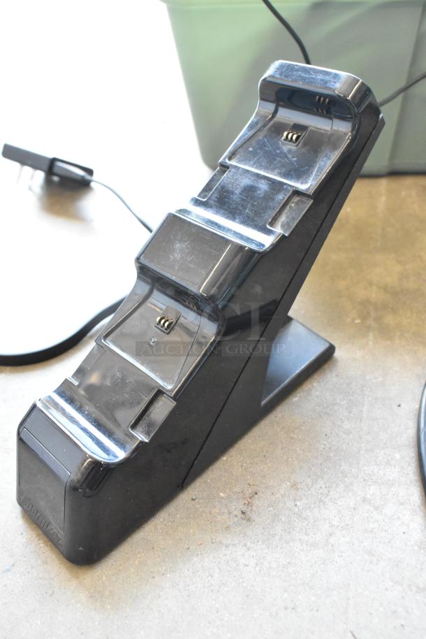 Anki charging unit in good condition with visible wiring in poly bin; minor surface scratches.