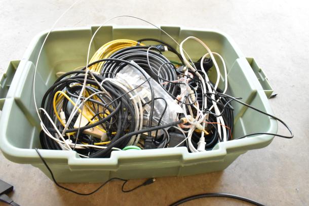 Lot of Anki unit and wiring in a green poly bin. Includes various cables and connectors. Condition appears used.