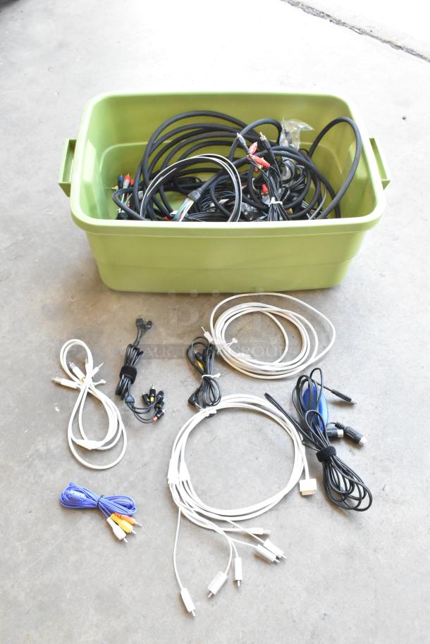 Green poly bin filled with assorted wiring and cables, some coiled neatly outside the bin. Various colors and connectors visible.