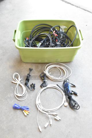 Green poly bin filled with assorted wiring and cables, some coiled neatly outside the bin. Various colors and connectors visible.