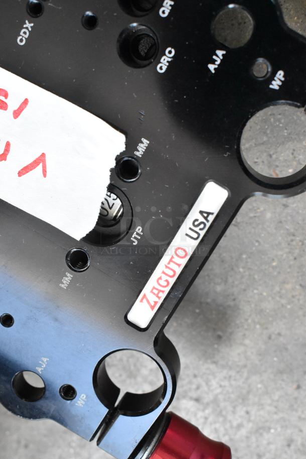 Zacuto USA mounting plate with visible engravings for various port types, in used condition, part of a mixed auction lot.