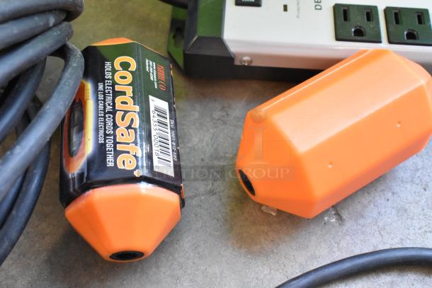 Lot of wiring and power strips including orange CordSafe holders with SKU tag in poly bin; used condition.