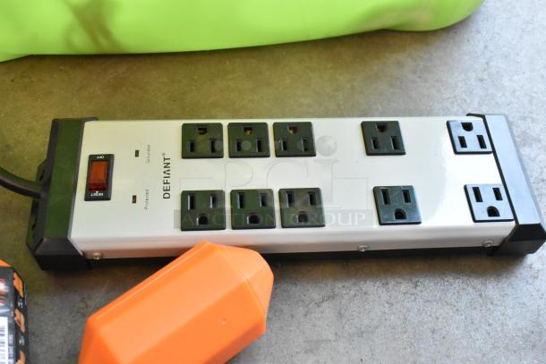 Defiant power strip with eight outlets and reset switch in a poly bin, part of a lot including wiring and other items.