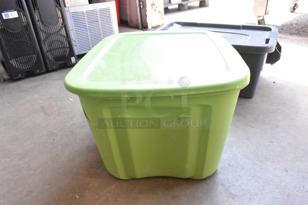 Green poly bin containing various items including wiring and power strips, auctioned as a lot. Condition appears used.